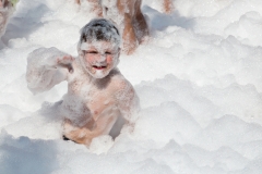 Children in the foam. Selective soft focus. A foam party