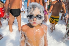 the boy in foam, dressed black glasses for swimming. a party.